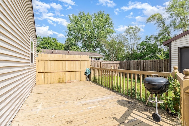 4411 W Michigan Ave, Saginaw, MI 48638 - wooden terrace with a fenced backyard and grilling area