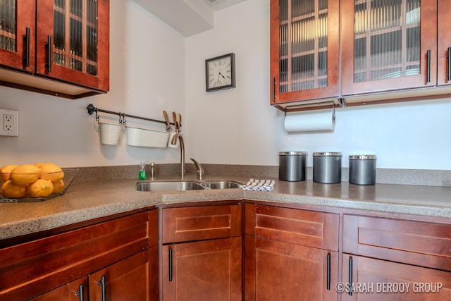 505 Cherry St SE Unit 512, Grand Rapids, MI 49503 - kitchen featuring a sink and glass insert cabinets