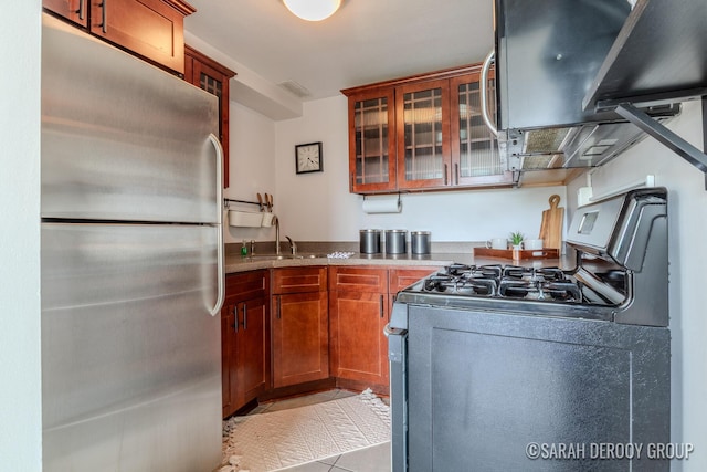 505 Cherry St SE Unit 512, Grand Rapids, MI 49503 - kitchen featuring appliances with stainless steel finishes, a sink, light tile patterned floors, glass insert cabinets, and range hood