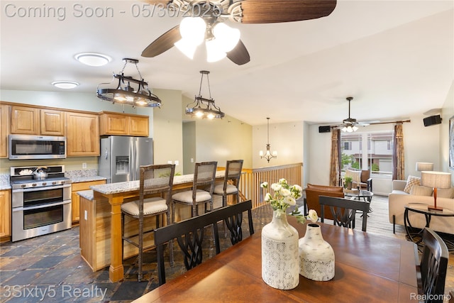 20791 Busenbark Ln, Brownstown, MI 48183 - dining space featuring ceiling fan, a chandelier, and vaulted ceiling