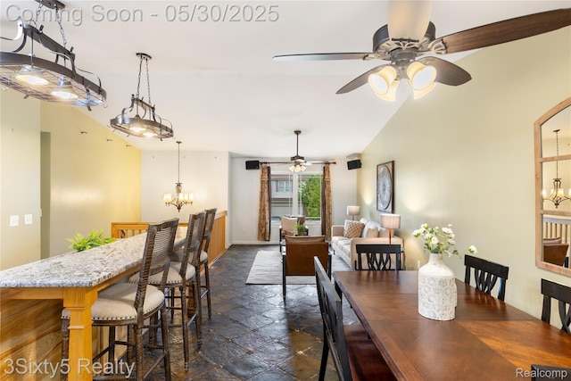 20791 Busenbark Ln, Brownstown, MI 48183 - dining room featuring a chandelier, stone tile flooring, ceiling fan, baseboards, and vaulted ceiling