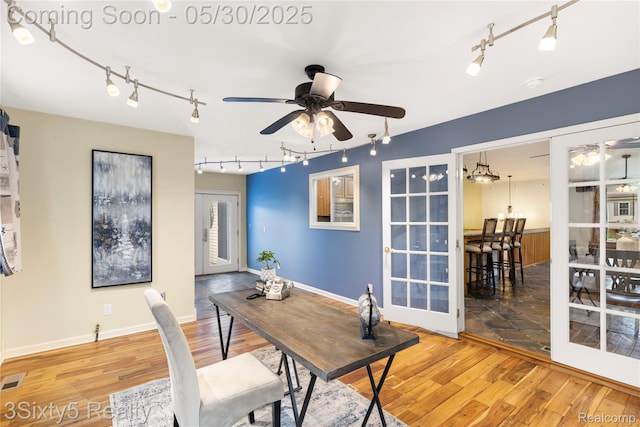 20791 Busenbark Ln, Brownstown, MI 48183 - office area featuring track lighting, a ceiling fan, wood finished floors, and baseboards