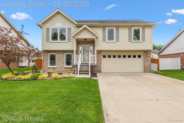 20791 Busenbark Ln, Brownstown, MI 48183 - split foyer home with brick siding, a garage, and concrete driveway