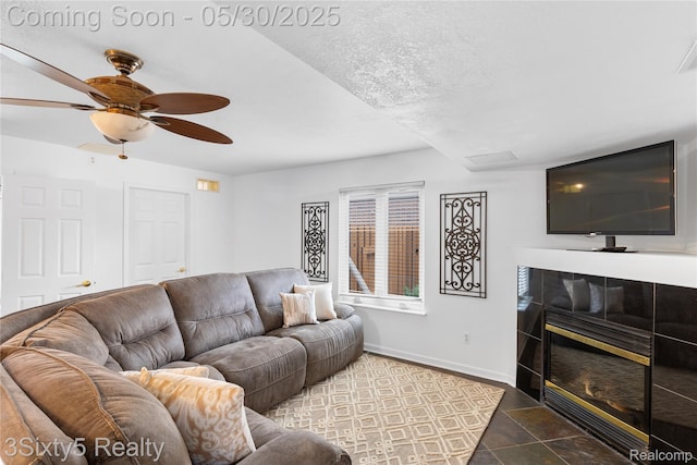 20791 Busenbark Ln, Brownstown, MI 48183 - living room featuring a ceiling fan, baseboards, and a tiled fireplace