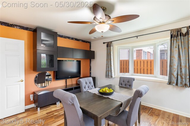20791 Busenbark Ln, Brownstown, MI 48183 - dining area featuring baseboards, ceiling fan, and light wood-style flooring