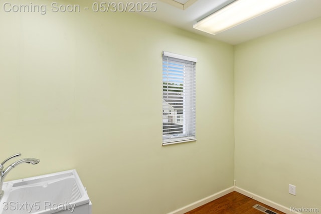 20791 Busenbark Ln, Brownstown, MI 48183 - laundry room with a sink, baseboards, and dark wood-style floors