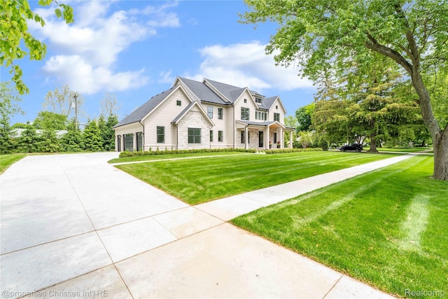 19138 Riverside Dr, Beverly Hills, MI 48025 - view of front of property featuring stone siding, concrete driveway, and a front yard