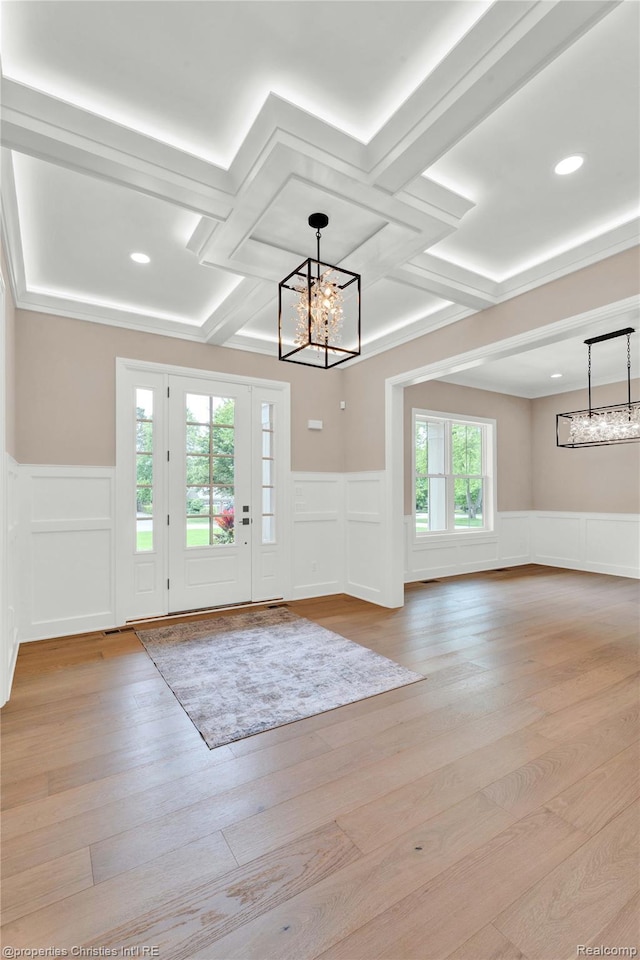 19138 Riverside Dr, Beverly Hills, MI 48025 - doorway featuring a chandelier, coffered ceiling, a decorative wall, wainscoting, and beam ceiling
