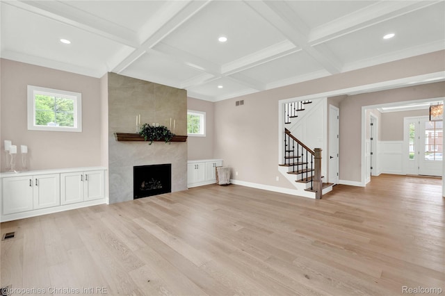 19138 Riverside Dr, Beverly Hills, MI 48025 - unfurnished living room featuring coffered ceiling, light wood finished floors, stairs, beam ceiling, and healthy amount of natural light