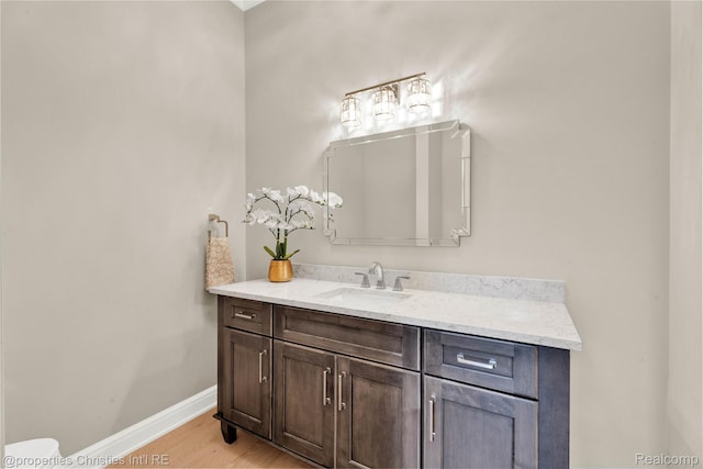 19138 Riverside Dr, Beverly Hills, MI 48025 - bathroom featuring vanity, baseboards, wood finished floors, and toilet