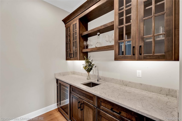 19138 Riverside Dr, Beverly Hills, MI 48025 - indoor wet bar featuring wine cooler, baseboards, and light wood-type flooring