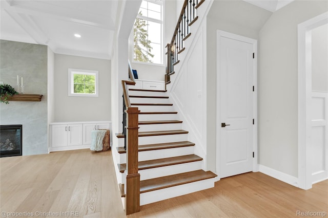 19138 Riverside Dr, Beverly Hills, MI 48025 - stairs featuring wood finished floors, a large fireplace, baseboards, and recessed lighting