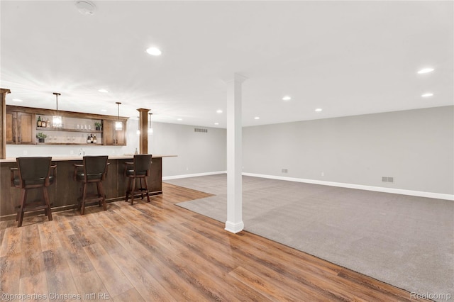 19138 Riverside Dr, Beverly Hills, MI 48025 - kitchen with open shelves, recessed lighting, a breakfast bar area, baseboards, and hanging light fixtures