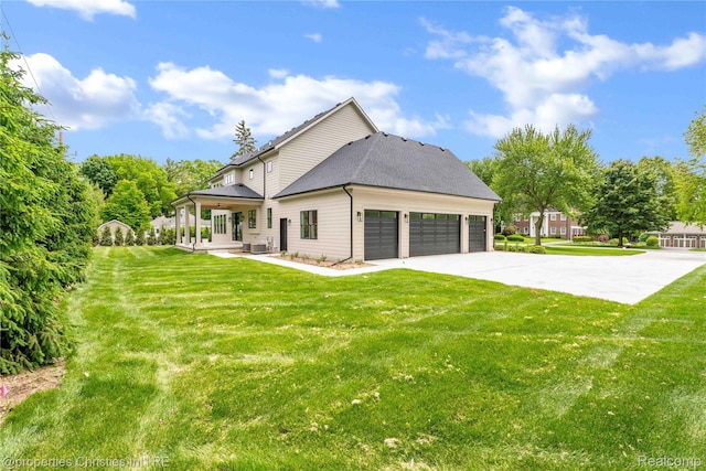 19138 Riverside Dr, Beverly Hills, MI 48025 - back of house with a garage, a lawn, driveway, and central AC