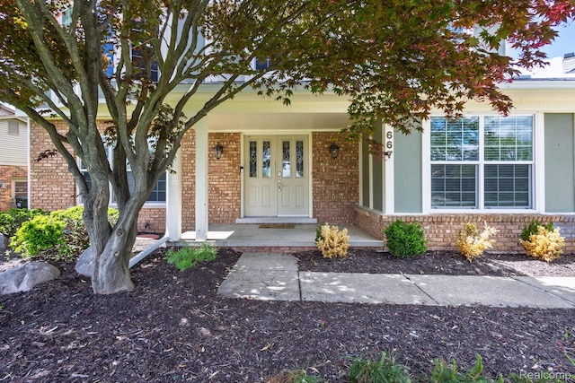667 Heritage Ln, Rochester, MI 48309 - doorway to property with a porch and brick siding