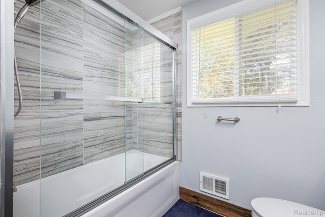 667 Heritage Ln, Rochester, MI 48309 - bathroom with shower / bath combination with glass door, toilet, and baseboards