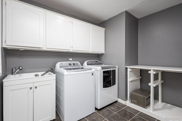 667 Heritage Ln, Rochester, MI 48309 - washroom with cabinet space, separate washer and dryer, dark tile patterned flooring, and baseboards