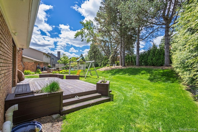 667 Heritage Ln, Rochester, MI 48309 - view of grassy yard featuring a deck and a playground