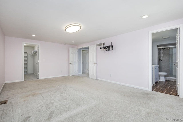 667 Heritage Ln, Rochester, MI 48309 - unfurnished bedroom with carpet, a walk in closet, recessed lighting, baseboards, and ensuite bath