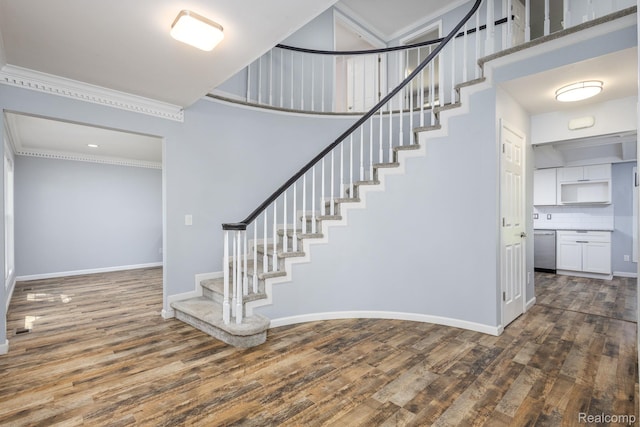 667 Heritage Ln, Rochester, MI 48309 - staircase featuring wood finished floors, crown molding, baseboards, and a high ceiling