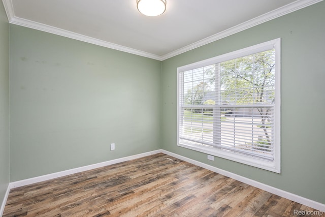 667 Heritage Ln, Rochester, MI 48309 - spare room featuring crown molding, baseboards, and wood finished floors