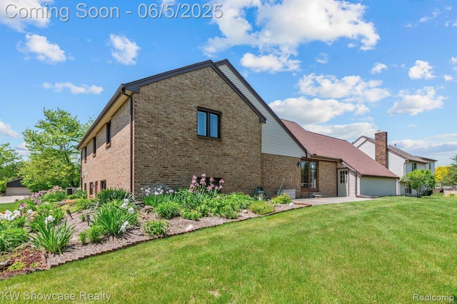 3430 Woodvalley Dr, Lapeer, MI 48446 - rear view of property featuring brick siding, a patio area, and a yard