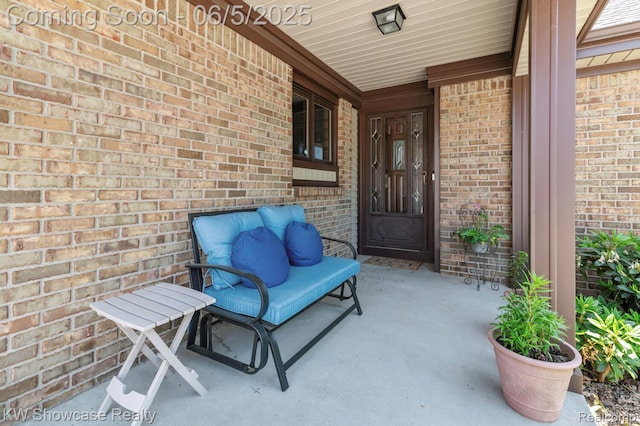 3430 Woodvalley Dr, Lapeer, MI 48446 - doorway to property featuring covered porch and brick siding
