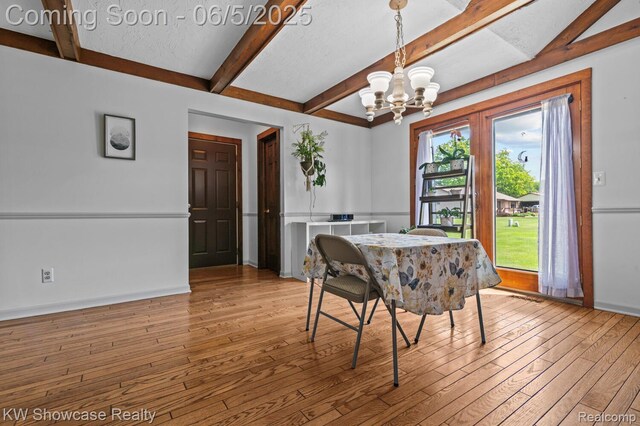 3430 Woodvalley Dr, Lapeer, MI 48446 - dining room featuring hardwood / wood-style flooring, beam ceiling, a chandelier, and baseboards