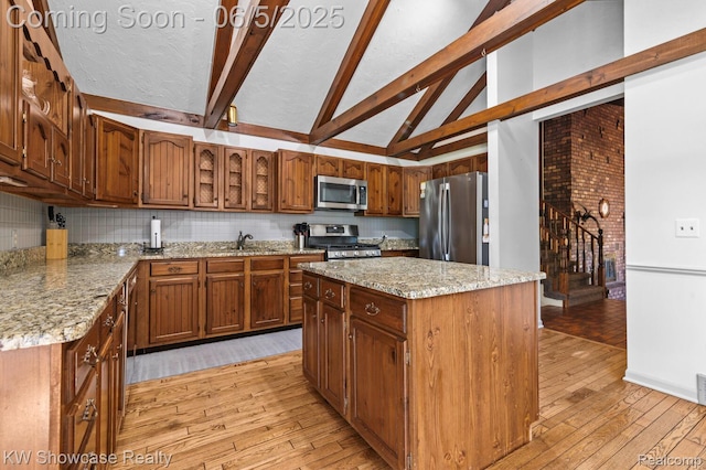3430 Woodvalley Dr, Lapeer, MI 48446 - kitchen featuring stainless steel appliances, light wood-style floors, a sink, beamed ceiling, and light stone counters