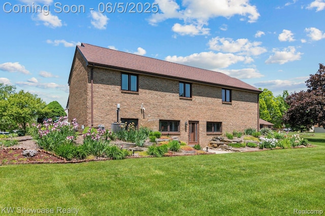 3430 Woodvalley Dr, Lapeer, MI 48446 - back of house with brick siding and a yard