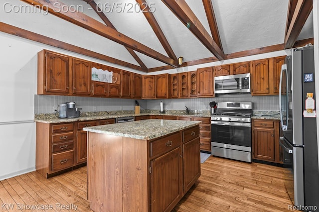 3430 Woodvalley Dr, Lapeer, MI 48446 - kitchen featuring stainless steel appliances, light wood-style floors, backsplash, and a kitchen island