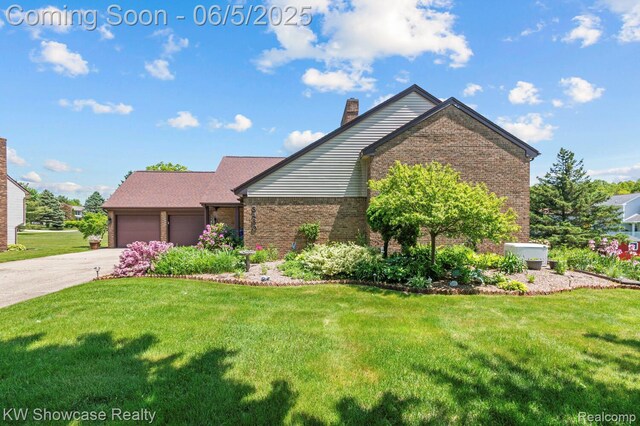3430 Woodvalley Dr, Lapeer, MI 48446 - view of front of property with brick siding, a front yard, a chimney, a garage, and concrete driveway