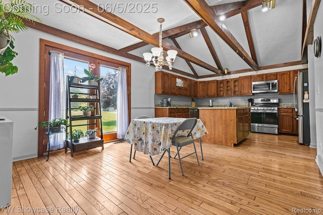 3430 Woodvalley Dr, Lapeer, MI 48446 - kitchen with stainless steel appliances, a chandelier, a center island, light wood-style flooring, and brown cabinets