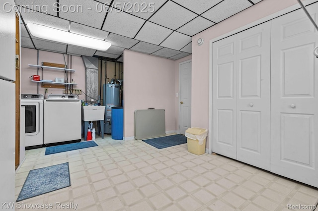 3430 Woodvalley Dr, Lapeer, MI 48446 - finished basement with washer and clothes dryer, tile patterned floors, water heater, a sink, and baseboards