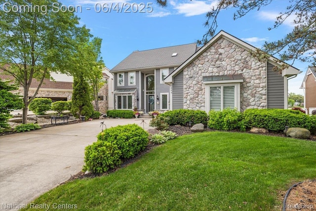 3448 Circle Dr, Commerce Twp, MI 48382 - view of front of home with stone siding, a front lawn, and driveway