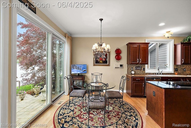 3448 Circle Dr, Commerce Twp, MI 48382 - dining area featuring light wood-type flooring, a chandelier, ornamental molding, and baseboards
