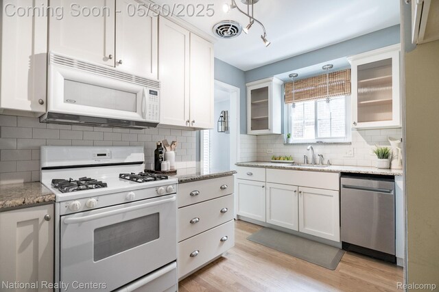 2029 Hubbell St, Dearborn, MI 48128 - kitchen featuring white appliances, a sink, white cabinetry, and tasteful backsplash