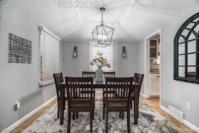 2029 Hubbell St, Dearborn, MI 48128 - dining area featuring a chandelier, light wood finished floors, and baseboards