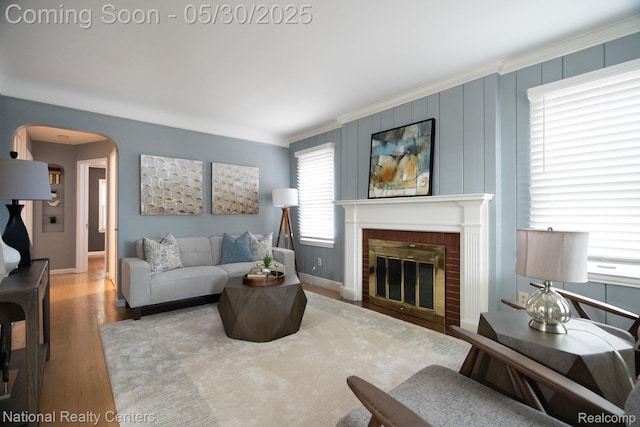 2029 Hubbell St, Dearborn, MI 48128 - living room with arched walkways, wood finished floors, baseboards, a fireplace, and crown molding