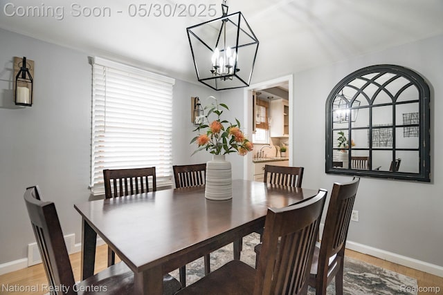 2029 Hubbell St, Dearborn, MI 48128 - dining space with a chandelier, light wood finished floors, and baseboards