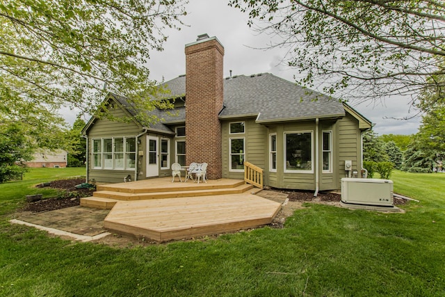 9117 Cambridge Dr, Saline, MI 48176 - back of property with roof with shingles, a chimney, a wooden deck, a yard, and a sunroom