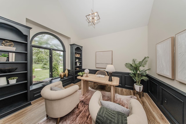 9117 Cambridge Dr, Saline, MI 48176 - office with light wood-type flooring, wainscoting, high vaulted ceiling, and a chandelier
