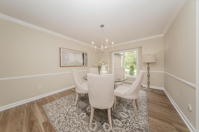 9117 Cambridge Dr, Saline, MI 48176 - dining space featuring a chandelier, wood finished floors, baseboards, and ornamental molding