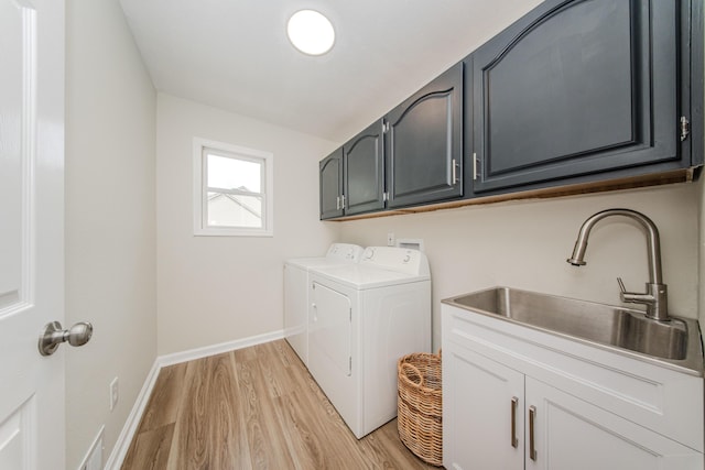 9117 Cambridge Dr, Saline, MI 48176 - washroom with cabinet space, washer and dryer, light wood-style flooring, and baseboards