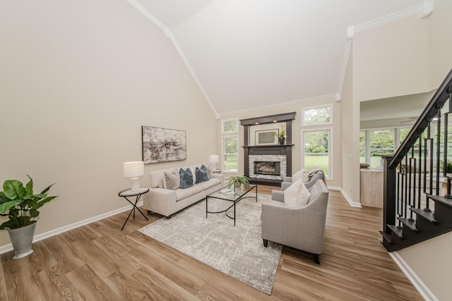 9117 Cambridge Dr, Saline, MI 48176 - living area featuring ornamental molding, baseboards, wood finished floors, high vaulted ceiling, and stairs