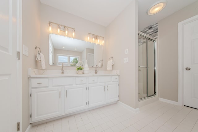 9117 Cambridge Dr, Saline, MI 48176 - bathroom with a shower stall, double vanity, baseboards, and tile patterned flooring