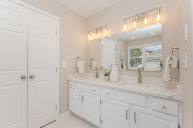 9117 Cambridge Dr, Saline, MI 48176 - bathroom featuring double vanity, tile patterned flooring, and baseboards