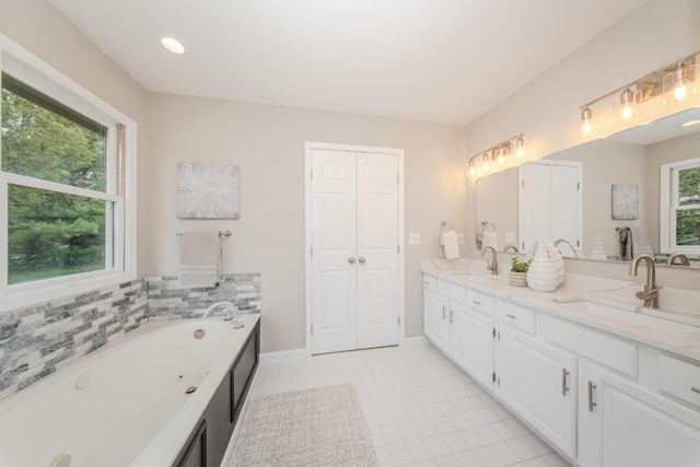 9117 Cambridge Dr, Saline, MI 48176 - bathroom featuring double vanity, a whirlpool tub, tile patterned flooring, and baseboards