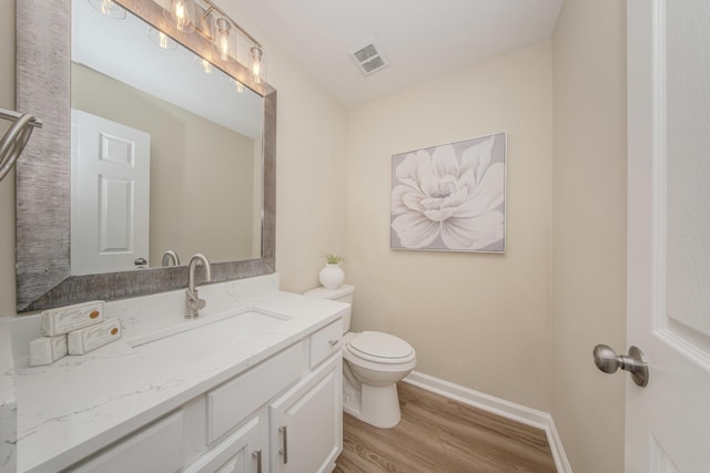 9117 Cambridge Dr, Saline, MI 48176 - bathroom featuring toilet, vanity, wood finished floors, and baseboards