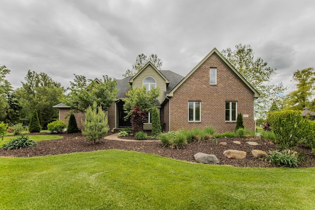 9117 Cambridge Dr, Saline, MI 48176 - traditional-style home featuring a front lawn and brick siding